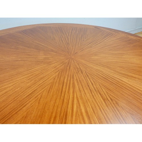 364 - A circular mahogany dining table, c.1960/70's, with sunburst pattern and eight stylised sectional bo... 