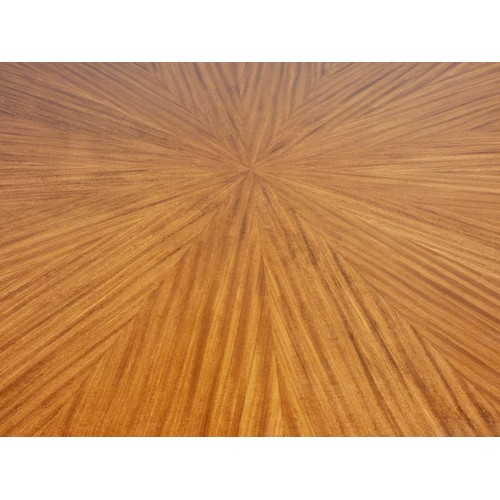 364 - A circular mahogany dining table, c.1960/70's, with sunburst pattern and eight stylised sectional bo... 