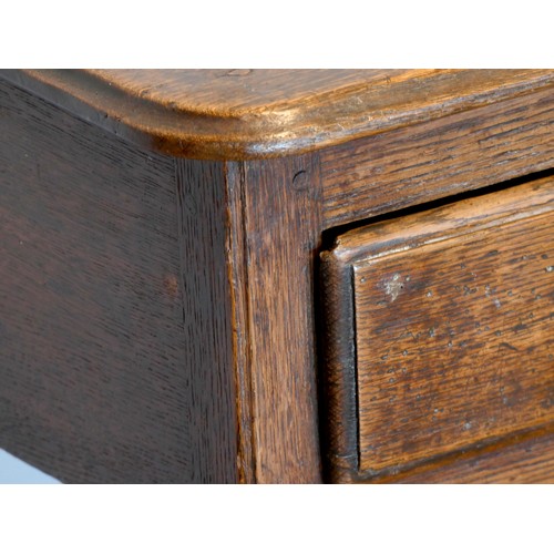 400 - A Georgian oak lowboy, having thumbnail edged top over two frieze drawers with brass loop handles, o... 