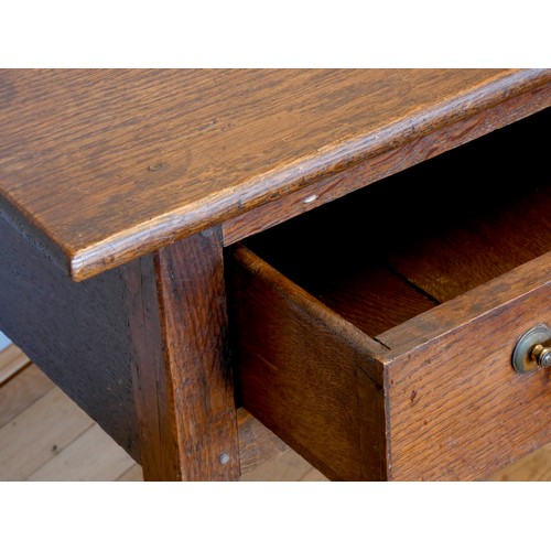 401 - A Georgian oak lowboy, having rounded edged top over a narrow central frieze drawer within a squared... 