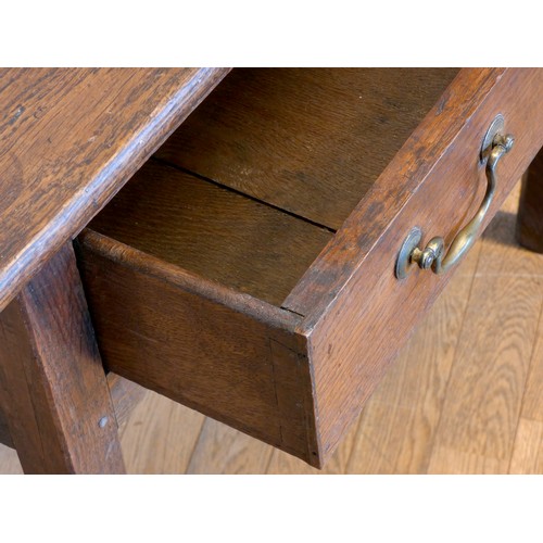 401 - A Georgian oak lowboy, having rounded edged top over a narrow central frieze drawer within a squared... 