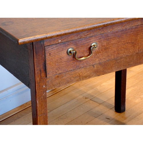 401 - A Georgian oak lowboy, having rounded edged top over a narrow central frieze drawer within a squared... 