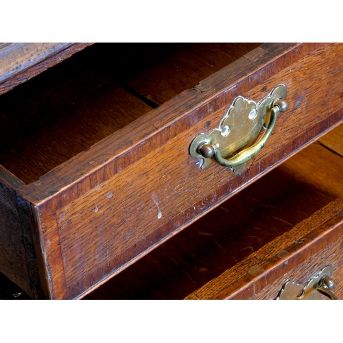 395 - A 19th century oak and parquetry inlay chest of drawers, having thumbnail edged top, over two short ... 