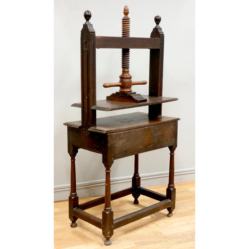 397 - A 19th century oak book press, having turned fruitwood central screw, flanked by oak joined square s... 