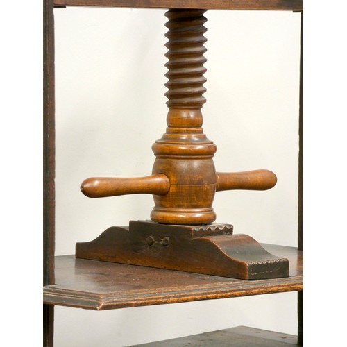 397 - A 19th century oak book press, having turned fruitwood central screw, flanked by oak joined square s... 