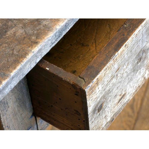 402 - An early 18th century lowboy, the two plank moulded top over a single frieze drawer with brass drop ... 