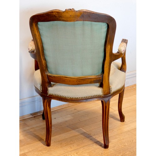 392 - A French Louis XVI style armchair, having carved walnut frame, tapestry upholstered, standing on scr... 