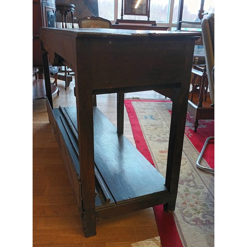 396 - A Georgian oak dresser base, the projecting top fitted with two long drawers having brass loop handl... 