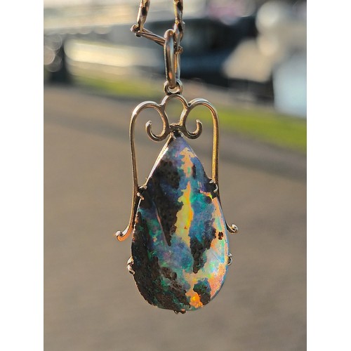 60 - A yellow gold mounted pear shape black boulder opal pendant, 25 x 14mm, to a later 9ct gold 48cm cha... 