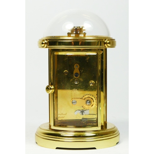 A London Clock Co brass carriage clock, of circular form with bevel