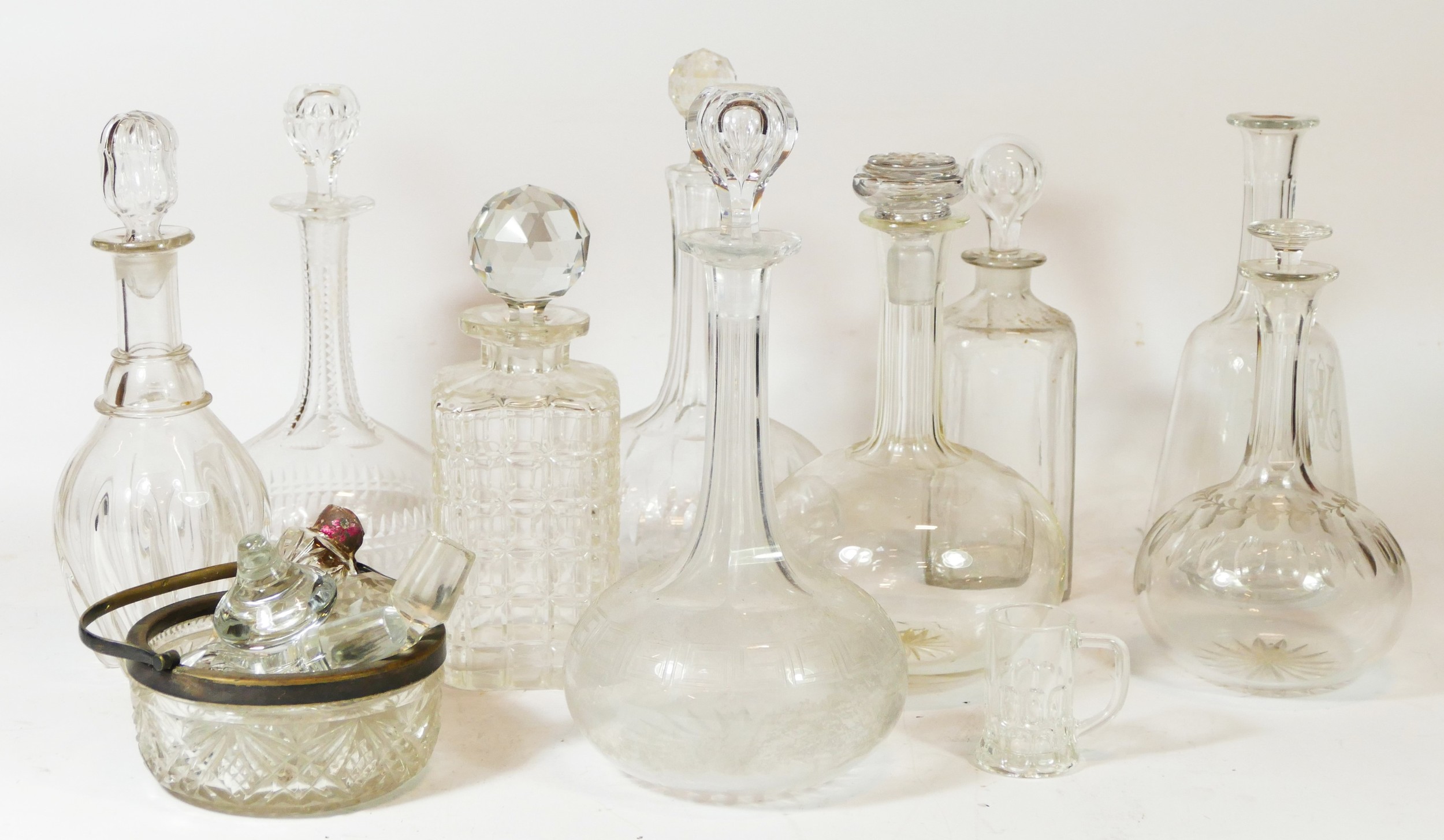 A collection of cut glass drink decanters together with a quantity of