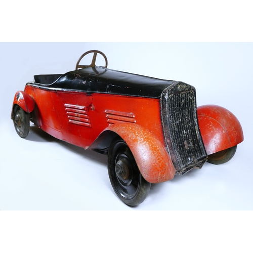Eureka Super Junior 35 child's pedal car, c.1935-38, metal body painted in red over black, metal disc wheels with solid Bergougnan rubber tyres, pedal drive, over painted chrome rear wings (possible replacements) and grill, 115 x 49cm.