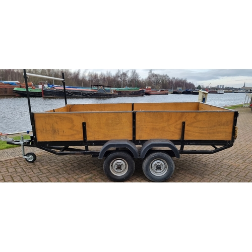 135 - A twin axle unbraked trailer with lighting board and ladder rack, Internal dimensions, 144 x 295cm