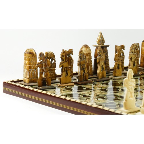 72 - An African (possibly Egyptian) chess board with pieces, board decorated with mother of pearl and bon... 