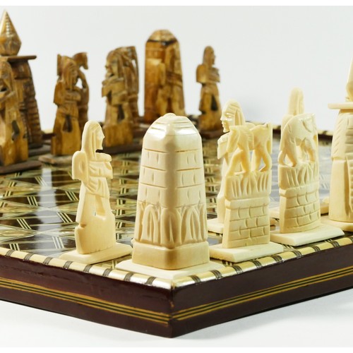 72 - An African (possibly Egyptian) chess board with pieces, board decorated with mother of pearl and bon... 