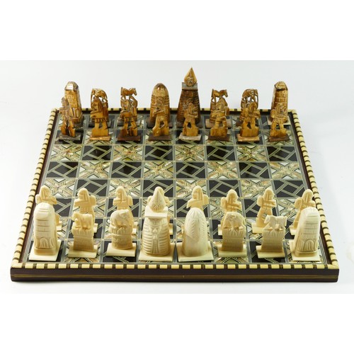 72 - An African (possibly Egyptian) chess board with pieces, board decorated with mother of pearl and bon... 