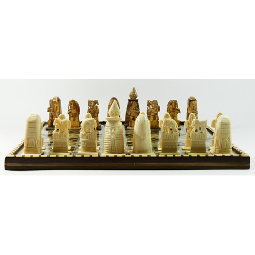 72 - An African (possibly Egyptian) chess board with pieces, board decorated with mother of pearl and bon... 