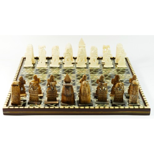 72 - An African (possibly Egyptian) chess board with pieces, board decorated with mother of pearl and bon... 