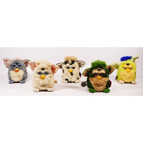 76 - Five Furby toys, made by Tiger, one with original tag and purple seal, one with original tag, one wi... 