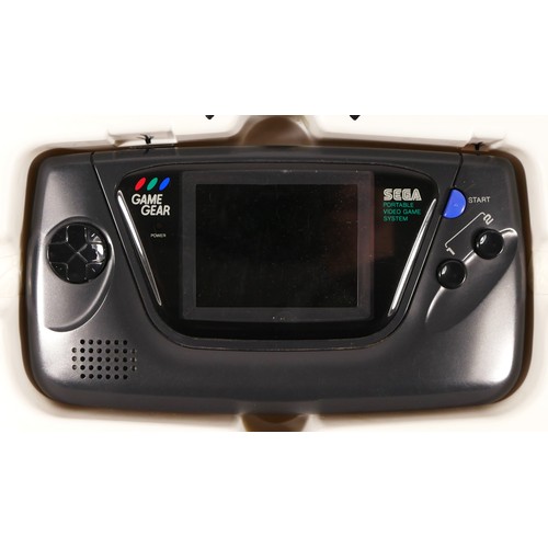 122 - A Sega Game Gear hand held console (serial No P313075561), in original box, together with two boxed ... 