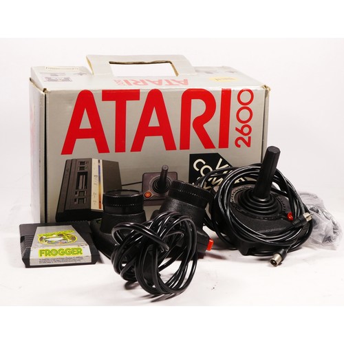 145 - A Atari 2600 console (serial No X1993569007), with power and AV cables, two paddle controllers, a jo... 