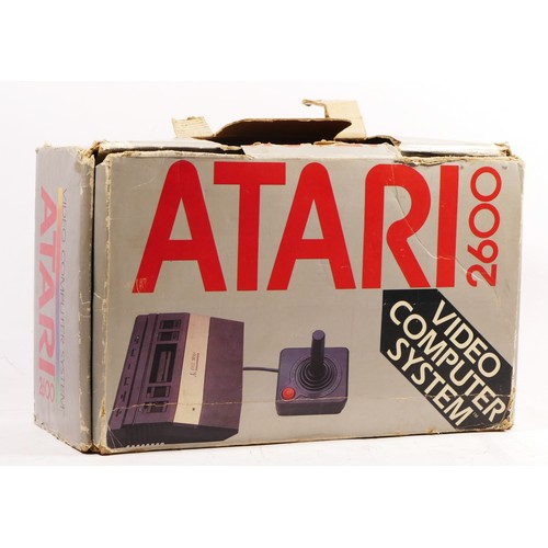 146 - A Atari 2600 console (serial No AT860202628), with power and AV cabled and two joysticks, boxed, wit... 