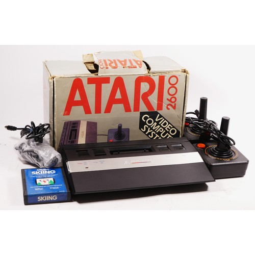 146 - A Atari 2600 console (serial No AT860202628), with power and AV cabled and two joysticks, boxed, wit... 