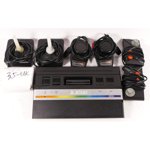 147 - LOT WITHDRAWN : A Atari 2600 console (serial No X1993569007), with power cable, two Atari driving co... 