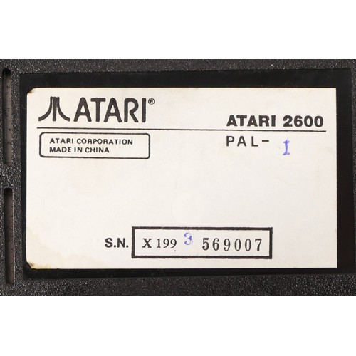 147 - LOT WITHDRAWN : A Atari 2600 console (serial No X1993569007), with power cable, two Atari driving co... 