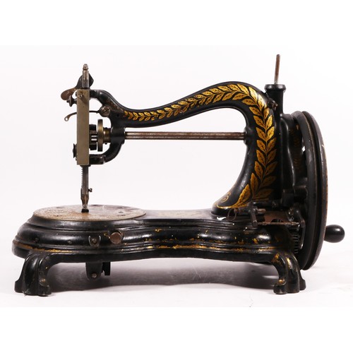 178 - A Jones hand sewing machine, serpentine/cat back, with gilt floral decoration, 38cm long