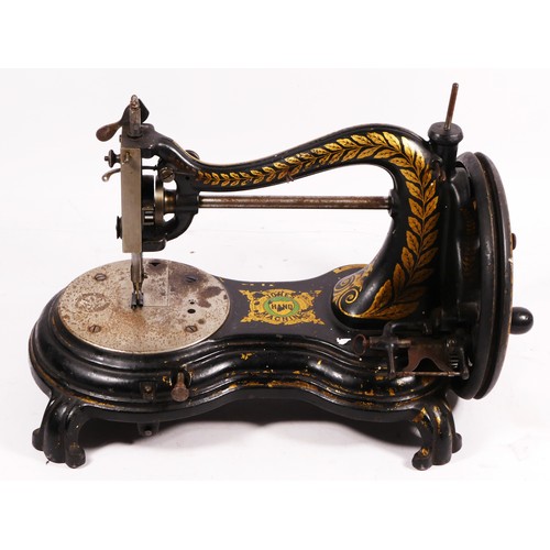 178 - A Jones hand sewing machine, serpentine/cat back, with gilt floral decoration, 38cm long