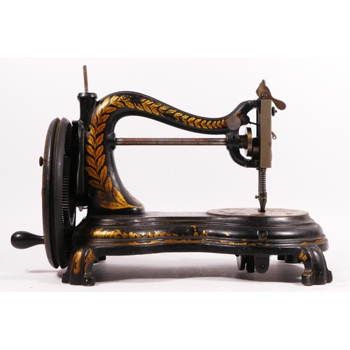 178 - A Jones hand sewing machine, serpentine/cat back, with gilt floral decoration, 38cm long