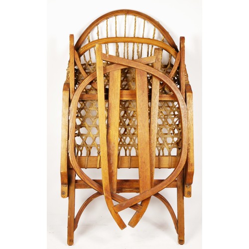 247 - A W.F. Tubbs Co SnoShu chair, folding rocking chair, with raw hide woven seat and back rest, 81cm x ... 