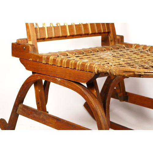 247 - A W.F. Tubbs Co SnoShu chair, folding rocking chair, with raw hide woven seat and back rest, 81cm x ... 