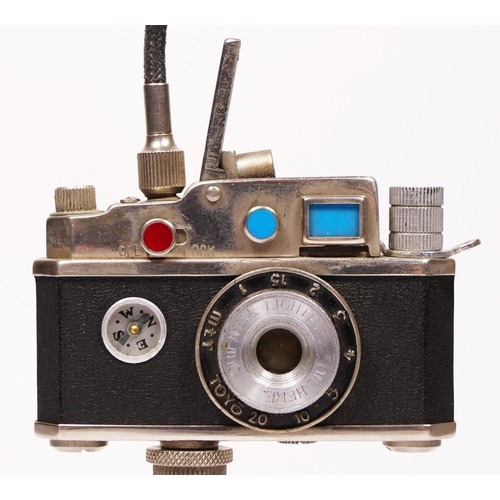 172 - A vintage novelty Photolite Japanese cigarette lighter in the form of a miniature camera complete wi... 