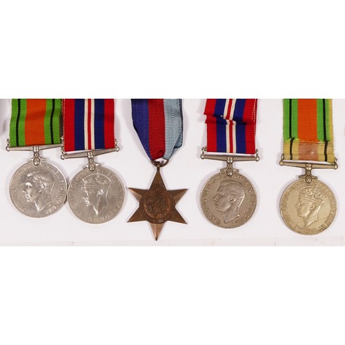 296 - Five WWII medals, 1939 - 1945 Star, two Defense and two War, together with related ephemera.