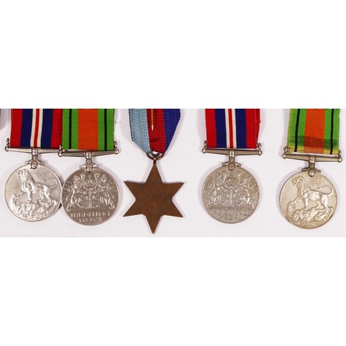 296 - Five WWII medals, 1939 - 1945 Star, two Defense and two War, together with related ephemera.