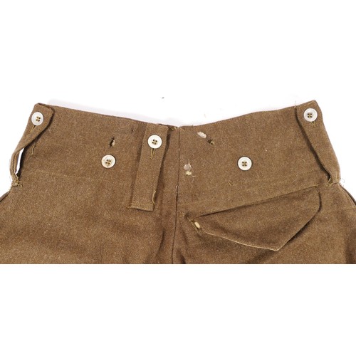 347 - A pair of Second World War Australian Battle dress trousers, signed 452 on internal waistband, toget... 