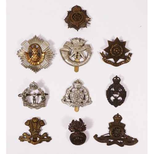 315 - A collection of ten cap badges to include Royal Electrical and Mechanical Engineers, The Royal Scots... 