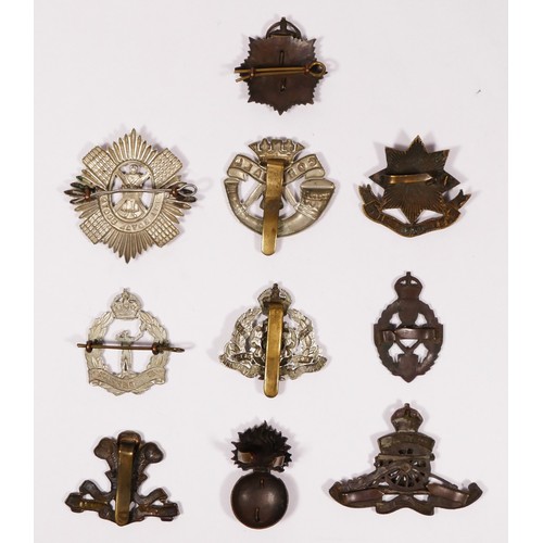 315 - A collection of ten cap badges to include Royal Electrical and Mechanical Engineers, The Royal Scots... 