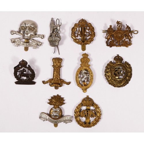 316 - A collection of ten cap badges to include The Royal Dublin Fusiliers, Royal Engineers and The Genera... 