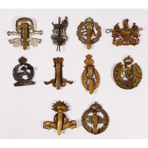 316 - A collection of ten cap badges to include The Royal Dublin Fusiliers, Royal Engineers and The Genera... 