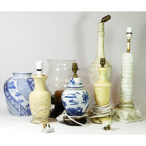 18 - A collection of table lamps, to include marble and stone examples, together with a blue & white orie... 