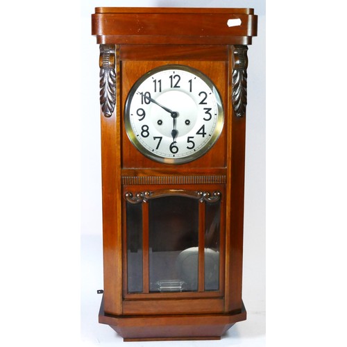 63 - A mid 20th century Vienna style wall clock, mahogany case with 8 day movement striking on gong.
71cm... 