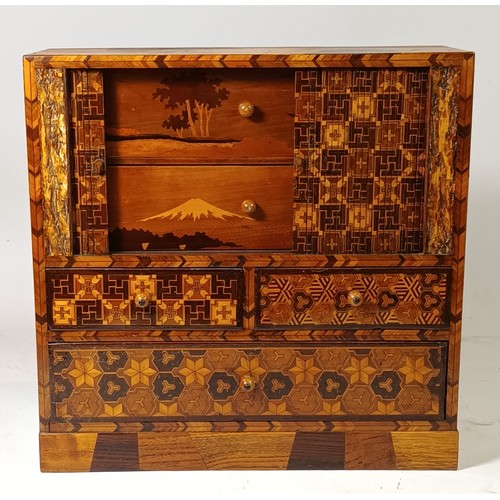 76 - A Japanese Yosegi Zaiku marquetry jewellery cabinet, late 19th century, having five fitted drawers, ... 