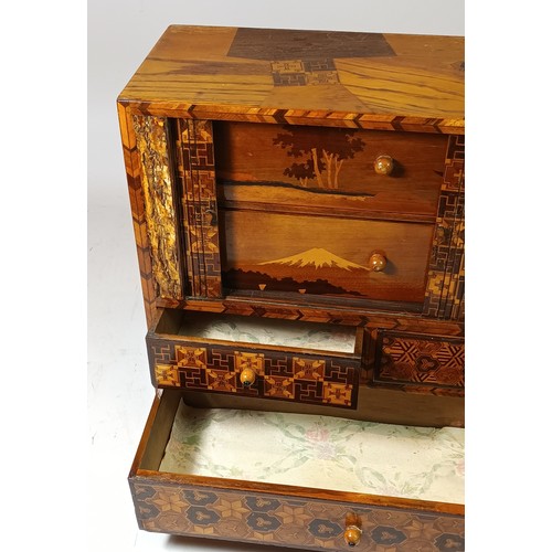 76 - A Japanese Yosegi Zaiku marquetry jewellery cabinet, late 19th century, having five fitted drawers, ... 