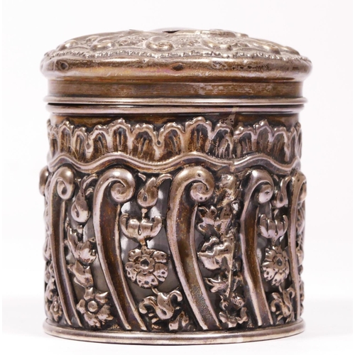 114 - An Edwardian silver glass jar with embossed and pierced frame, Chester 1902, height 7cm