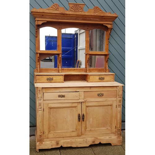 362 - A stripped pine kitchen dresser, with moulded cornice above a three tier plate rack, with frieze dra... 