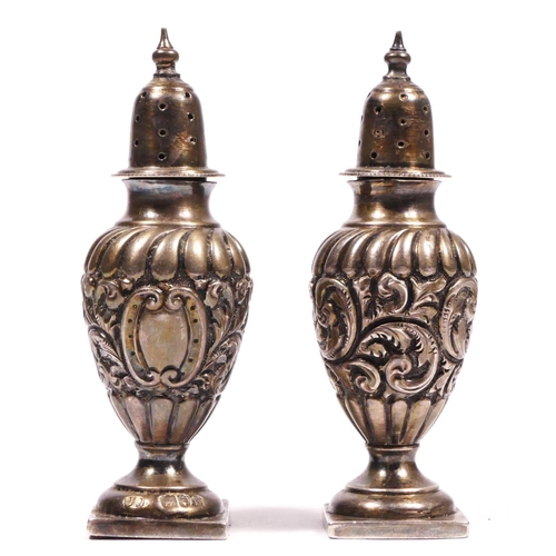 100 - A Victorian silver pair of pepper pots, London 1897, loaded, 9cm