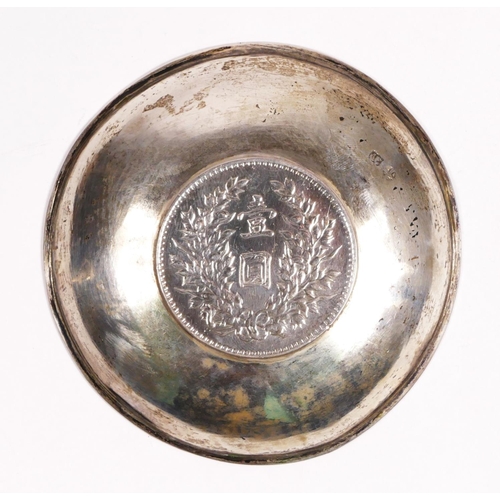 106 - A Chinese silver Yuan Shih-Kai dollar coin mounted in a pin tray with engraved dragon decoration, di... 
